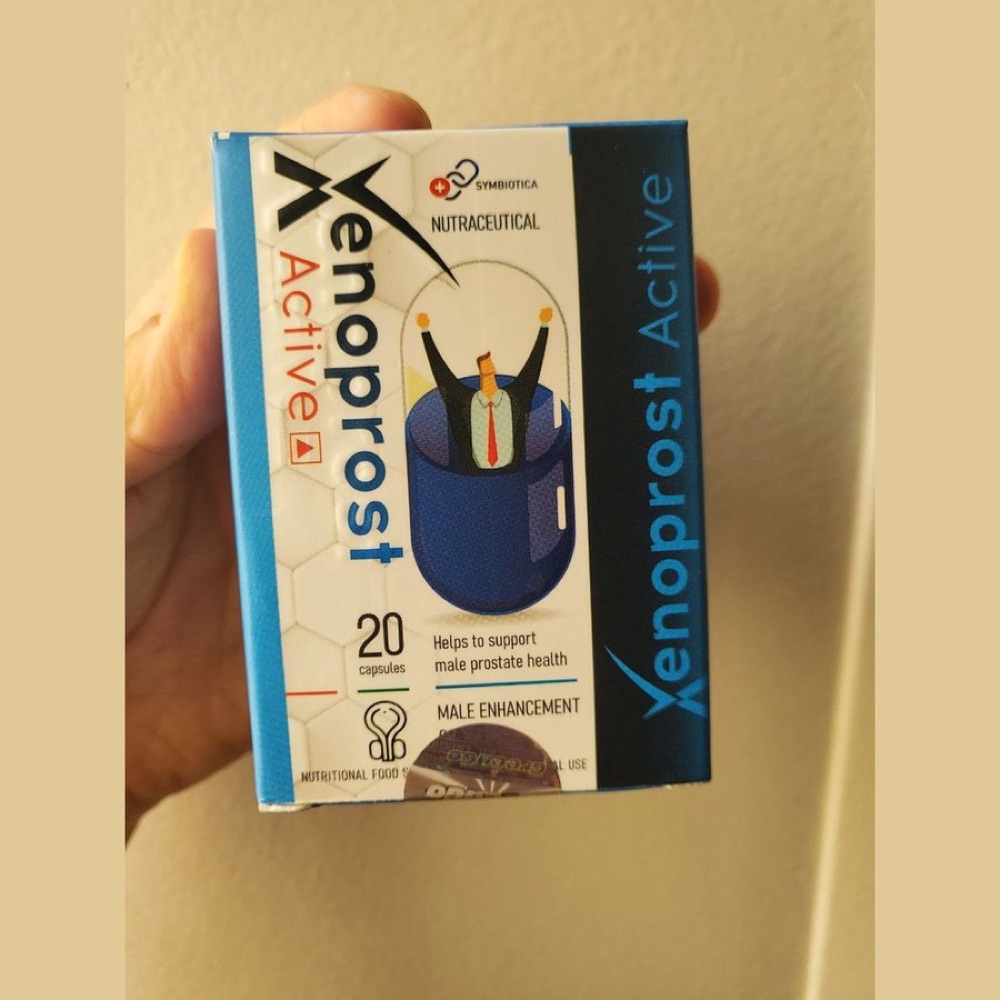 Xenoprost Active carton with blister strip of blue-and-white capsules